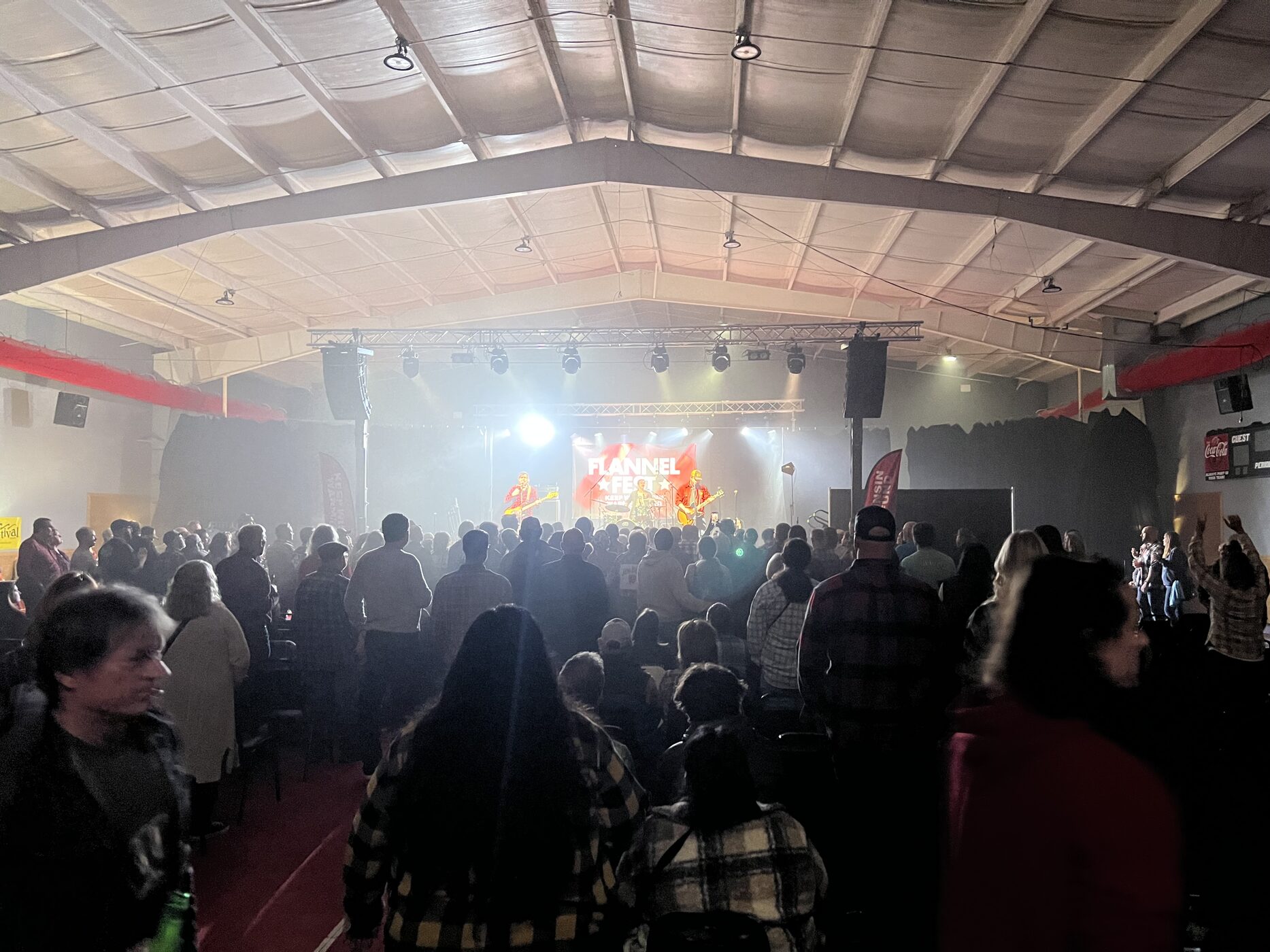A crowd watching a concert in an indoor event hall at Flannel Fest