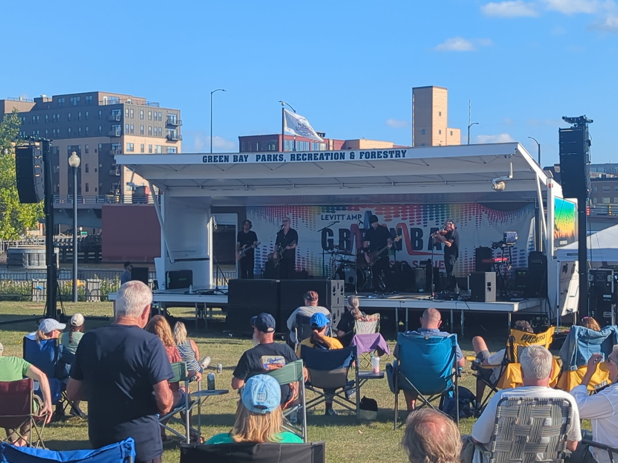 An audience watching a band perform at Levitt AMP Green Bay