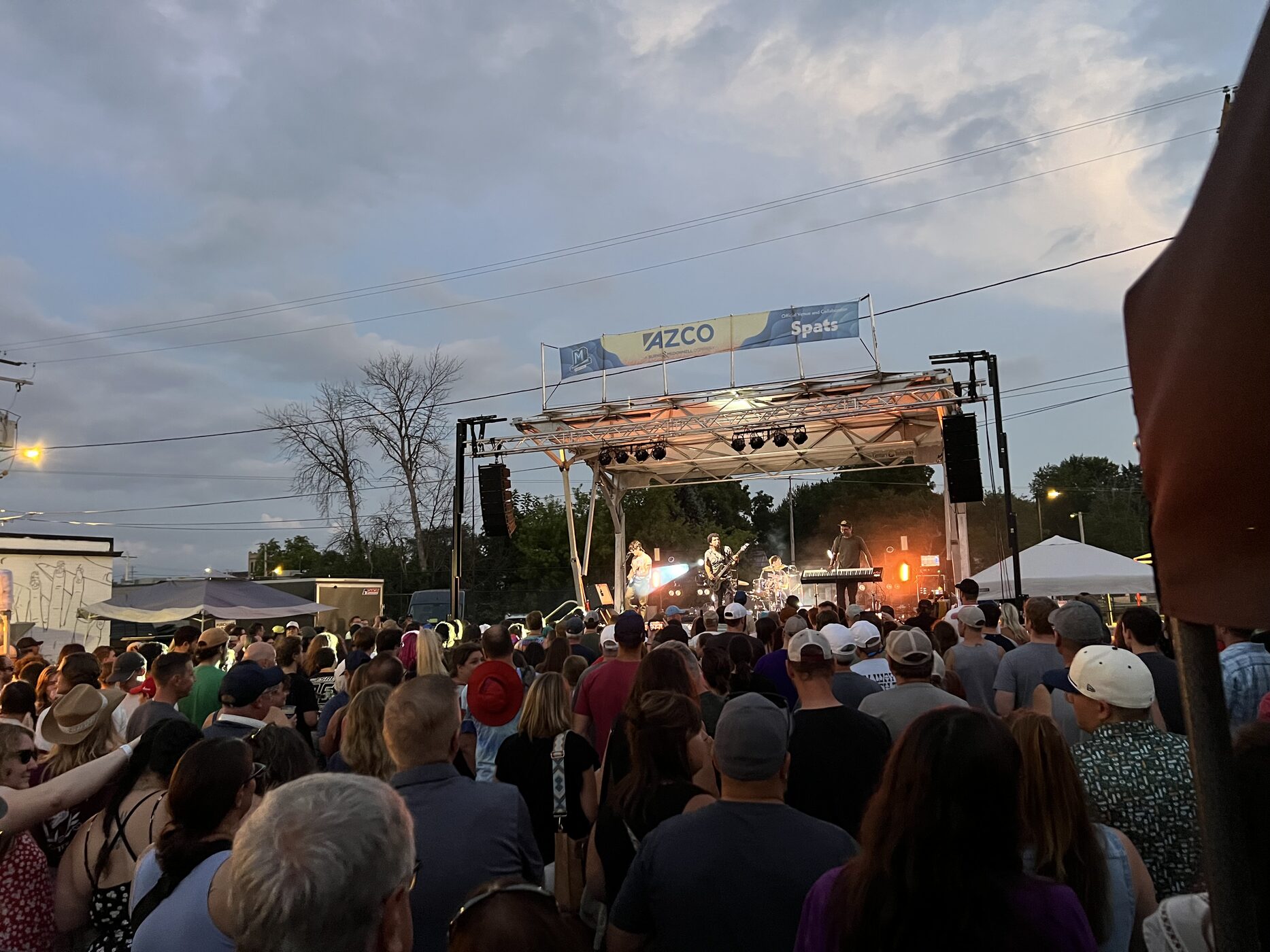 A crowd watching a live outdoor performance at Mile of Music in Appleton